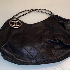 Chanel shoulder bag with silver tone CC medallion.